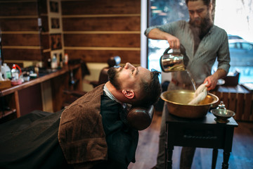 Man at barbershop, barber pours water into a bowl