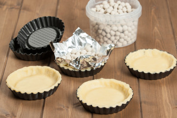 Cooking Process Of Tartlets. Ceramic Baking Beans. Tins.
