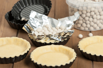 Cooking Process Of Tartlets. Ceramic Baking Beans. Tins.