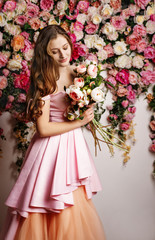 Young beautiful girl at the flower interior