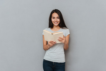 Fototapeta premium Smiling woman holding book