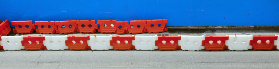 Orange and white interlocking construction barrier.