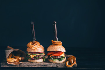 Two mouth-watering, delicious homemade burger used to chop beef. on the wooden table. The burgers...