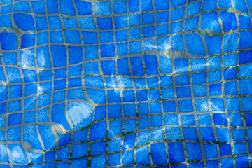 beautiful clear blue water in swimming pool mosaic with water blur