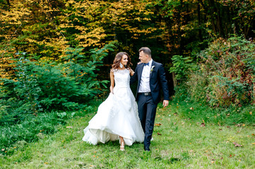 beautiful couple husband and wife are walking in the park