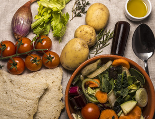 Italian vegetable minestrone soup with potatoes, carrots, onion, potatoes and bread