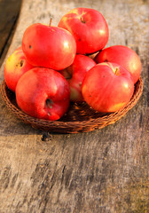 Red apples on wooden background