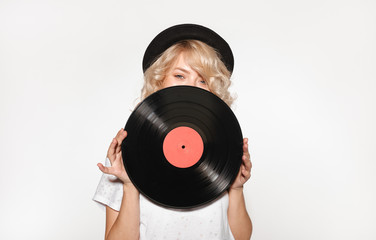Pretty blond closing face with vinyl
