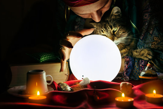 Gypsy woman fortune teller holding cat in her arms