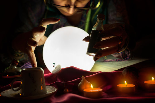 Fortune teller woman staring in crystal ball