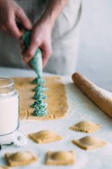 The man is cooking Ravioli with spinach and ricotta cheese