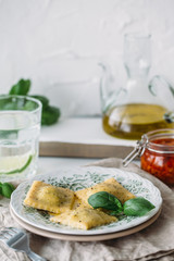 The man is cooking Ravioli with spinach and ricotta cheese