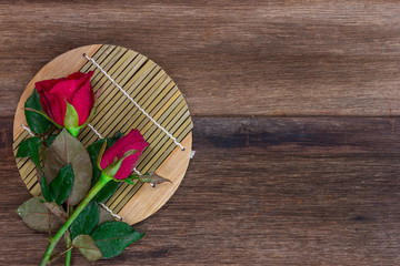  red roses on old wood background (valentine concept)