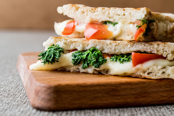 Turkish Bazlama Tost / Toast sandwich with melted cheese, tomatoes and dill.