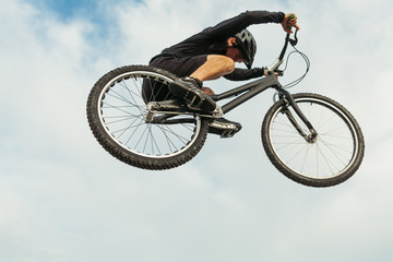 Fototapeta na wymiar Man jumping on a bike