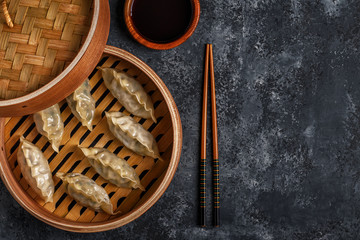 Fresh dumplings on a dark stone background.