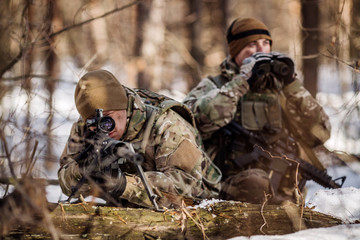 team of special forces weapons in cold forest. Winter warfare and military concept