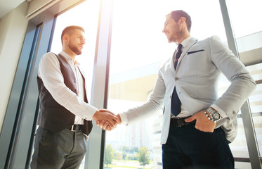 Business people shaking hands, finishing up a meeting.