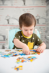 Little boy playing puzzle