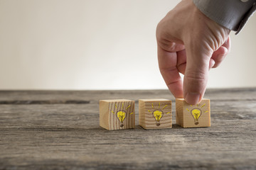 Shining light bulbs drawn on wooden blocks