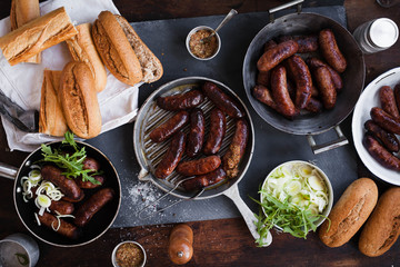 Party table with grilled sausages and sweet potatoes fries.