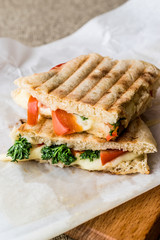 Turkish Bazlama Tost / Toast sandwich with melted cheese, tomatoes and dill.