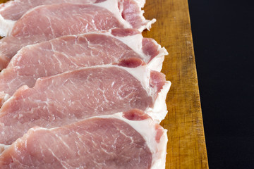 Raw meat and knife on wood board