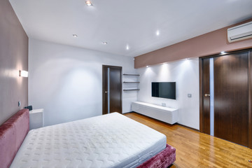 Russia, Moscow - modern designer renovation in a luxury building. Stylish bedroom interior with double bed