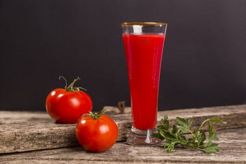 tomato juice based drink on black background.