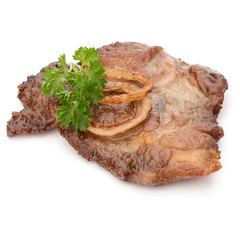 Cooked fried pork meat with parsley herb leaves and onion slices garnish isolated on white background cutout