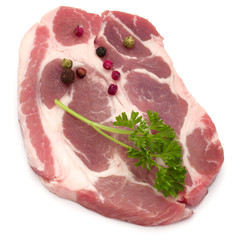 Raw pork neck chop meat with parsley herb leaves and peppercorn spices garnish isolated on white background cutout