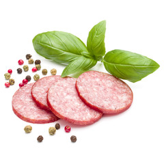 Salami smoked sausage slices, basil leaves and peppercorns isolated on white background cutout