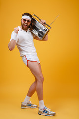 Screaming young man wearing sunglasses holding tape recorder