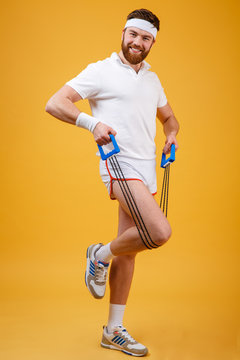Portrait of a sporty man exercising with rubber expander