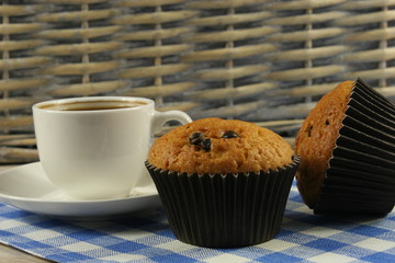 Chocolate muffins with a Cup of coffee on the table