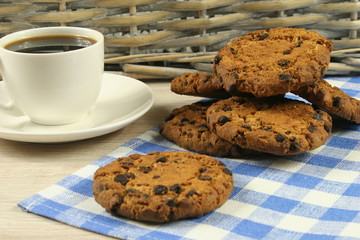 Coffee cup with oatmeal cookie chocolate on wooden background