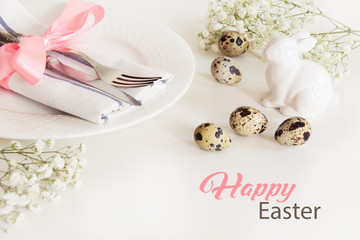 Elegance table setting with pink ribbon and flower on white background. Easter romantic dinner. Top view.
