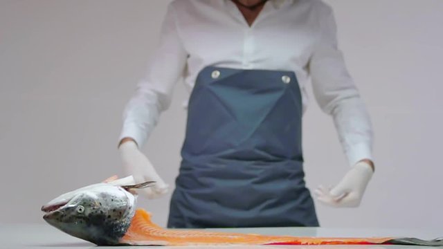 SLOW MOTION FOOD: chef throws a fish skeleton on the table