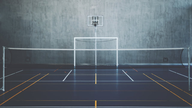 Front view of court in gymhall, indoors modern contemporary office stadium with basketball basket and hoop, football goal, tennis court with net and colored marking, concrete wall in background