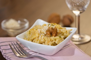 Serving of risotto (paella,pilaf) with walnuts and white wine
