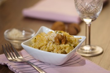 Serving of risotto (paella,pilaf) with walnuts and white wine