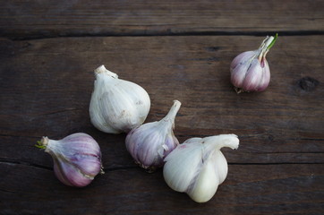 Garlic cloves on wooden old natural vintage background
