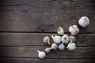 Garlic cloves on wooden old natural vintage background