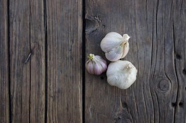 Garlic cloves on wooden old natural vintage background