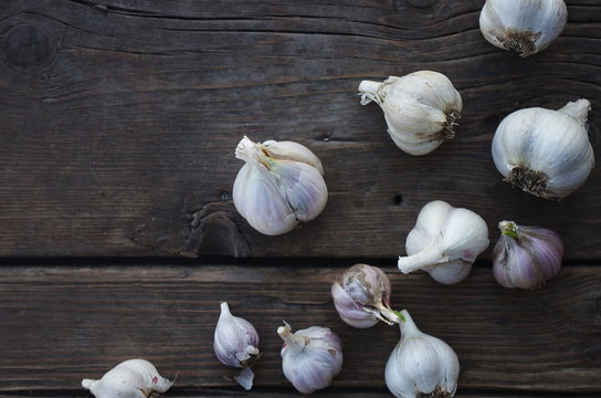 Garlic cloves on wooden old natural vintage background