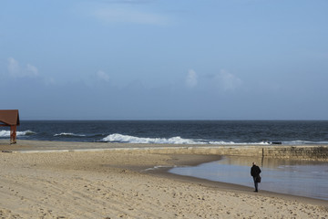 Fototapeta na wymiar Businessman is rambling along the shore in Estoril, Portugal