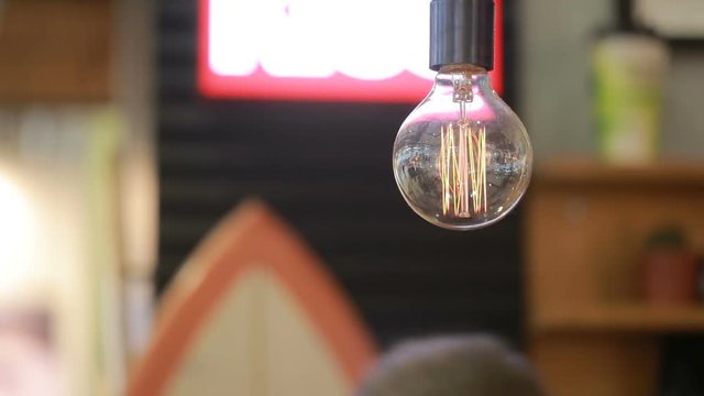 Incandescent lamp on the background of blurred moving objects