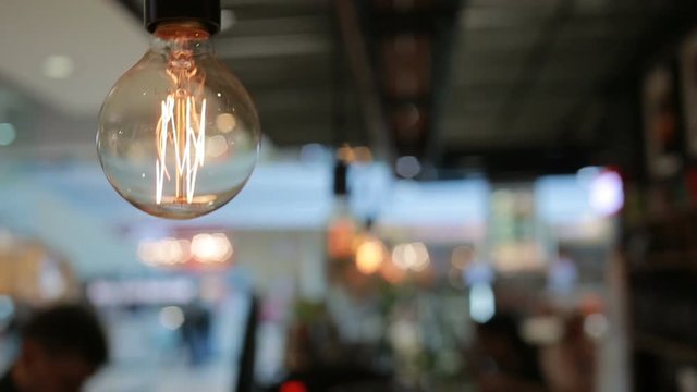 Incandescent lamp on the background of blurred moving objects