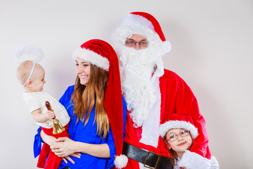 Happy family together with Santa Claus.