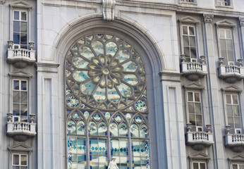 beautiful stained glass window on classical european style building with church facade